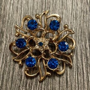 Blue and gold brooch